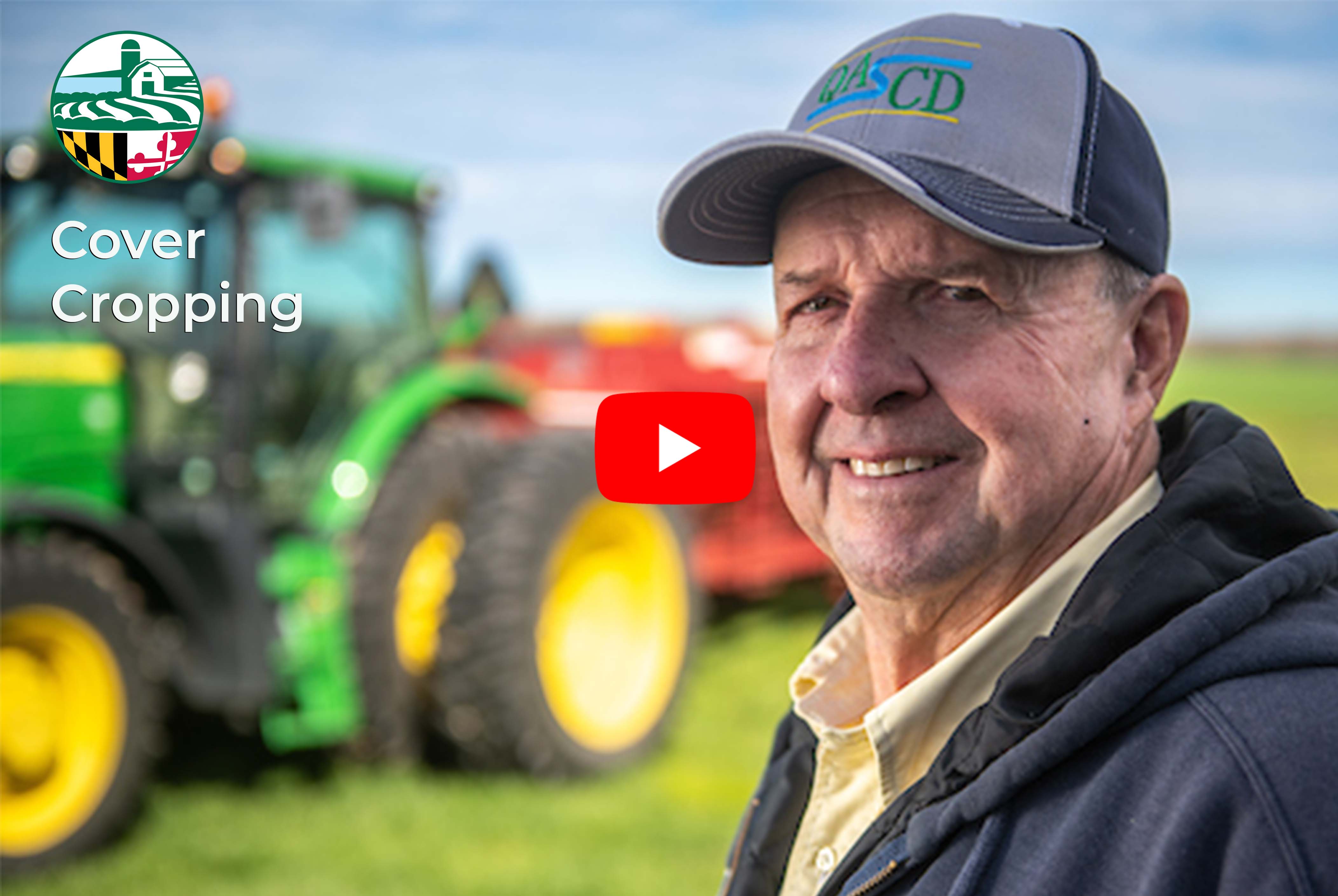 Farmer standing in a field with a green tractor nearby and video link, image copyright Edwin Remsberg